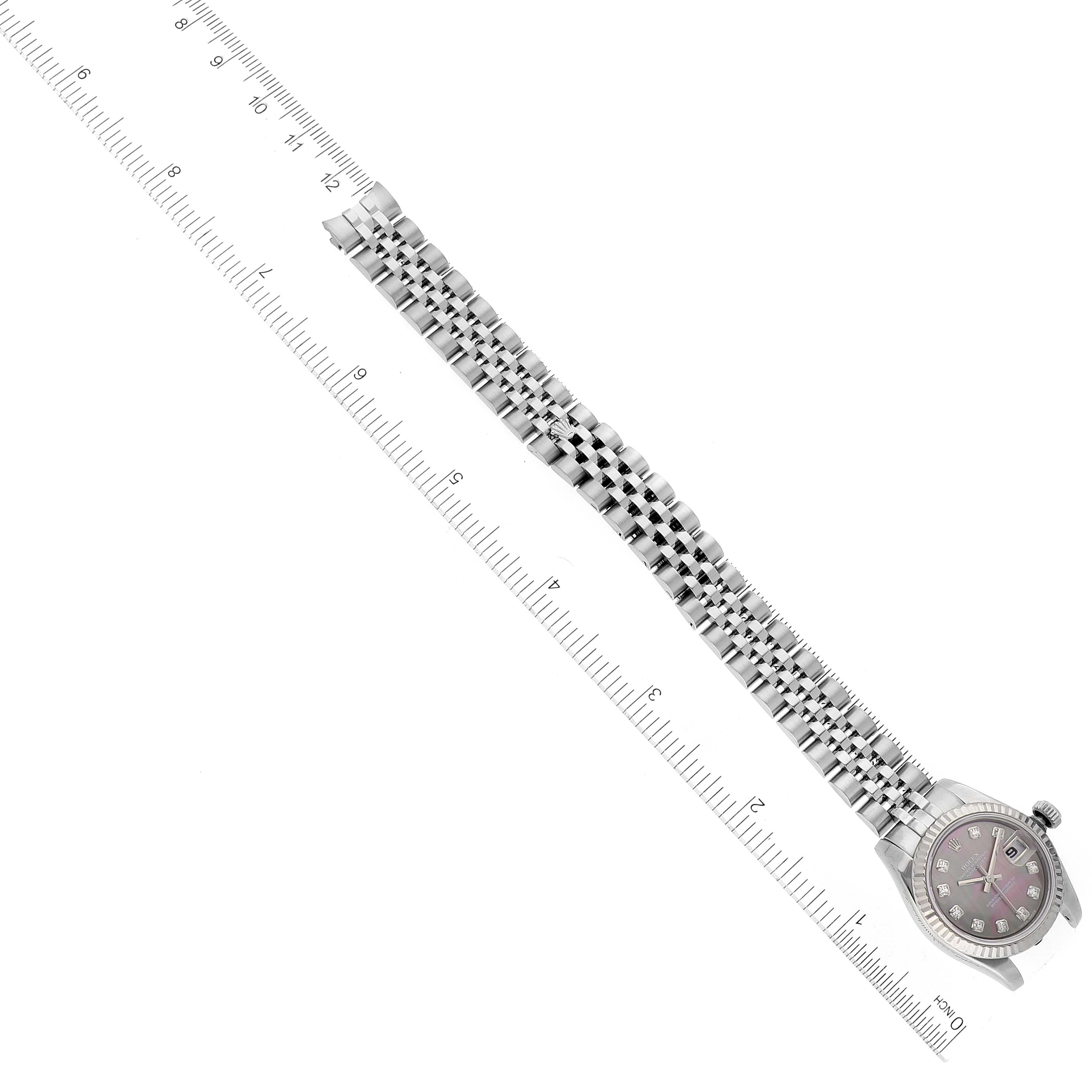The image shows a Rolex Datejust 179174 Women's Stainless Steel Mother of Pearl Dial 179174 Women's Stainless Steel Mother of Pearl Dial watch lying flat, with the bracelet extended next to a ruler for scale.