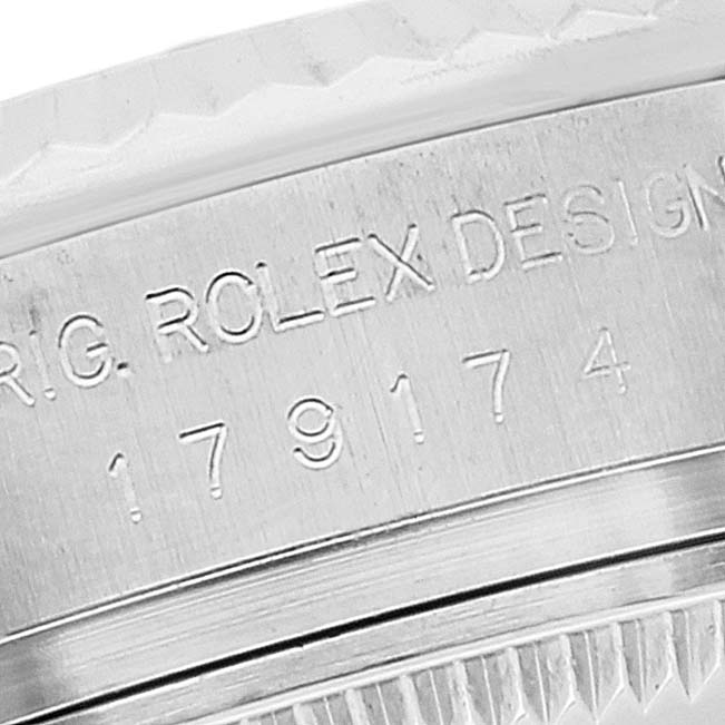 This close-up image shows the engraved serial number and part of the bezel of a Rolex Datejust 179174 Women's Stainless Steel Mother of Pearl Dial 179174 Women's Stainless Steel Mother of Pearl Dial watch.