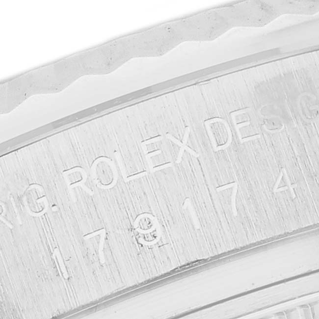 The image shows an engraved side of the Rolex Datejust 179174 Women's Stainless Steel Mother of Pearl Dial 179174 Women's Stainless Steel Mother of Pearl Dial's bezel or case with visible text and numbers.