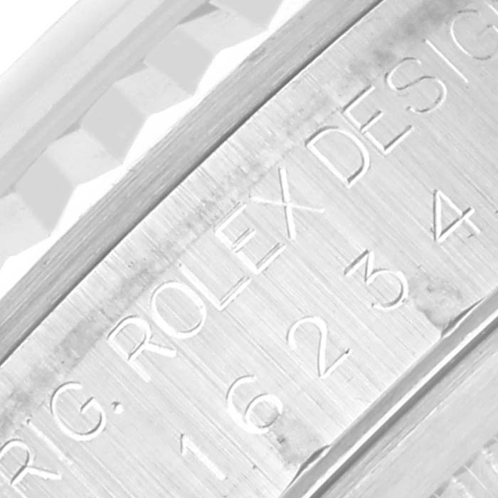 The image shows a close-up of the engraved serial number and branding on a Rolex Datejust 16234 Men's Stainless Steel Silver Dial 16234 Men's Stainless Steel Silver Dial watch bezel.