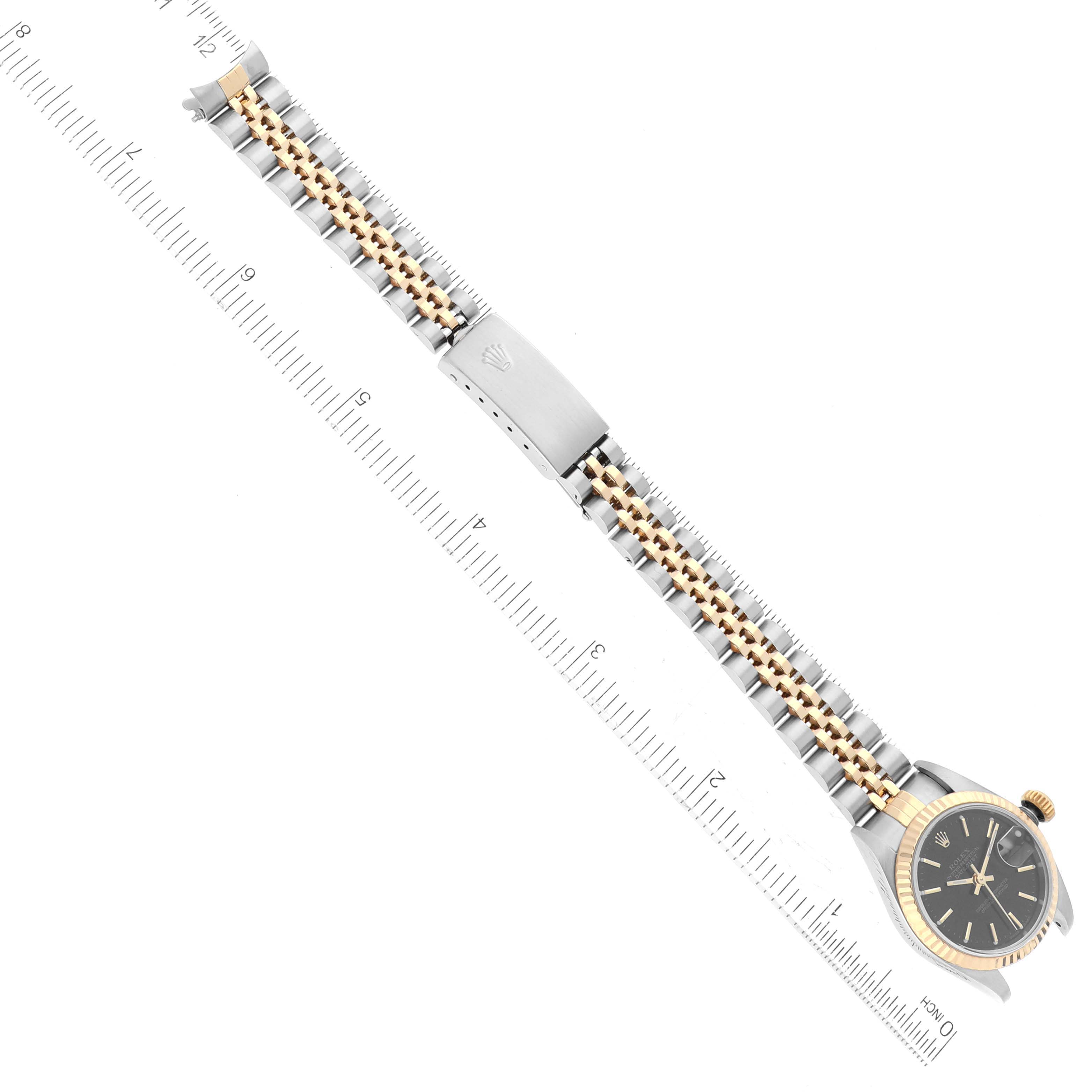 The Rolex Datejust 79173 Women's Steel and Gold (two tone) Black Dial 79173 Women's Steel and Gold (two tone) Black Dial watch is shown from an overhead angle, displaying the full bracelet and watch face.