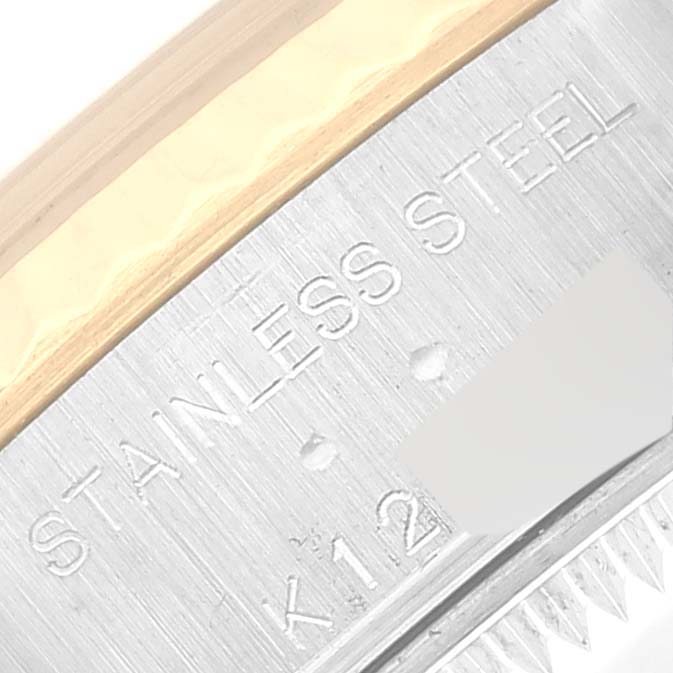 This image shows a close-up angle of the side of a Rolex Datejust 79173 Women's Steel and Gold (two tone) Black Dial 79173 Women's Steel and Gold (two tone) Black Dial watch case, displaying the "STAINLESS STEEL" engraving.