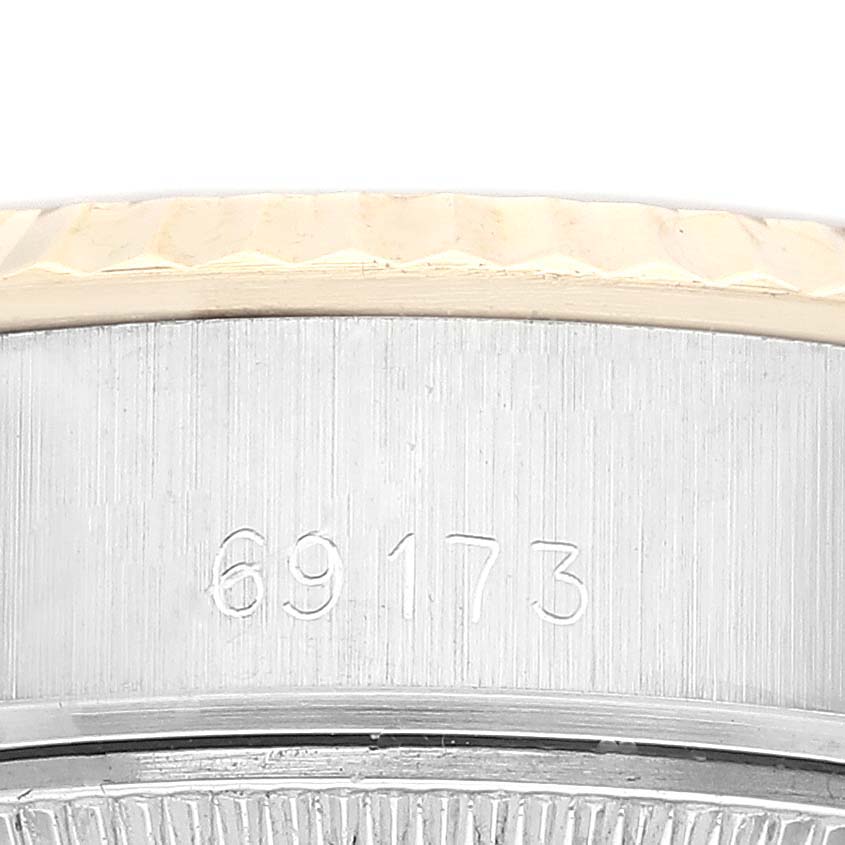 This close-up image of a Rolex Datejust 69173 Women's Steel and Gold (two tone) Champagne Dial 69173 Women's Steel and Gold (two tone) Champagne Dial watch shows part of the bezel and the serial number.