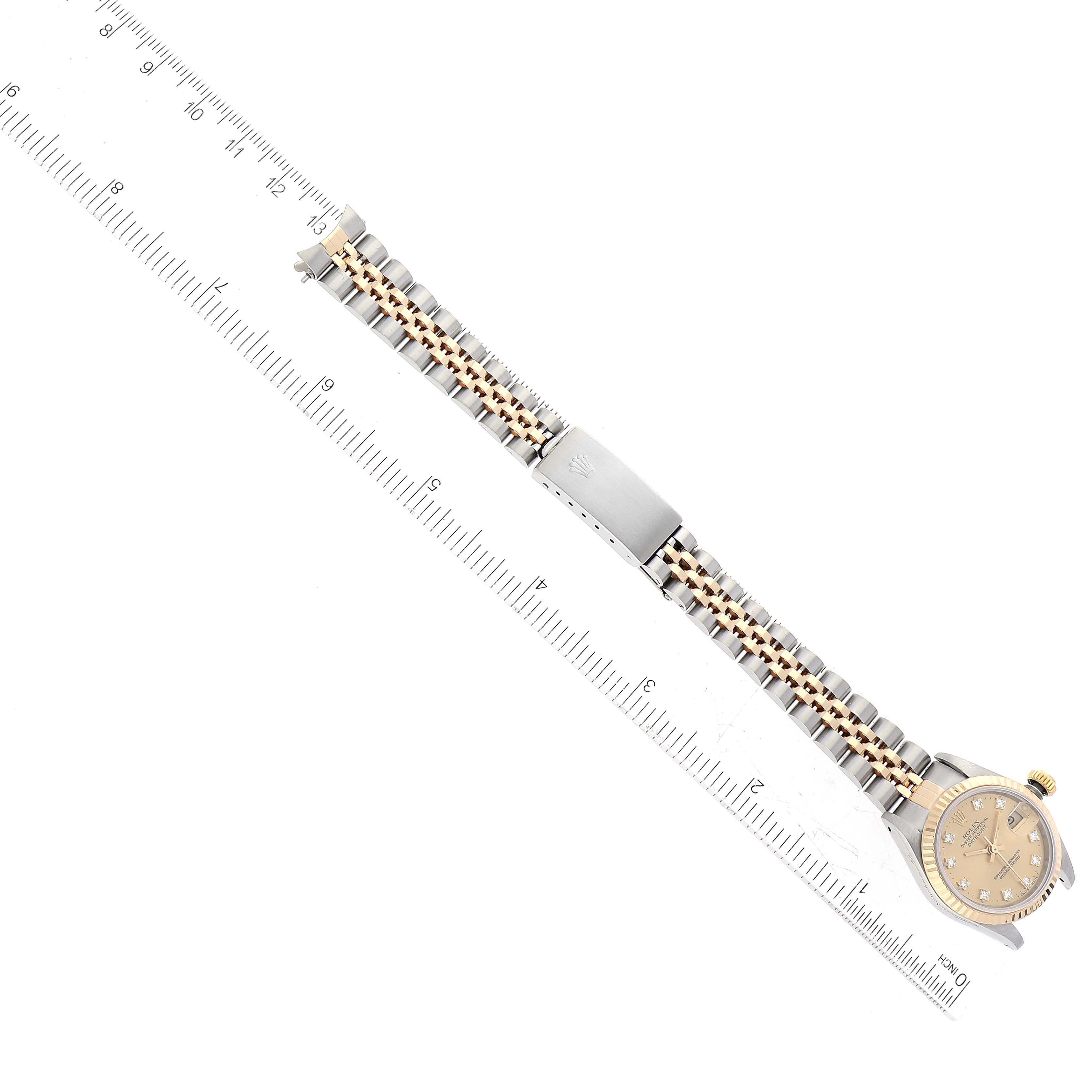 The image shows an aerial view of a Rolex Datejust 69173 Women's Steel and Gold (two tone) Champagne Dial 69173 Women's Steel and Gold (two tone) Champagne Dial watch, displaying the entire watch and bracelet alongside a ruler.