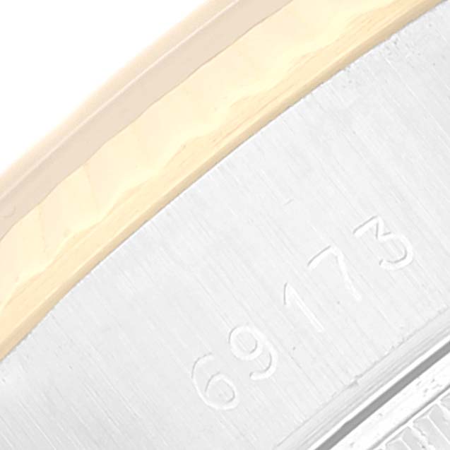 This image shows a close-up view of the engraved serial number on the case side of a Rolex Datejust 69173 Women's Steel and Gold (two tone) Champagne Dial 69173 Women's Steel and Gold (two tone) Champagne Dial watch.