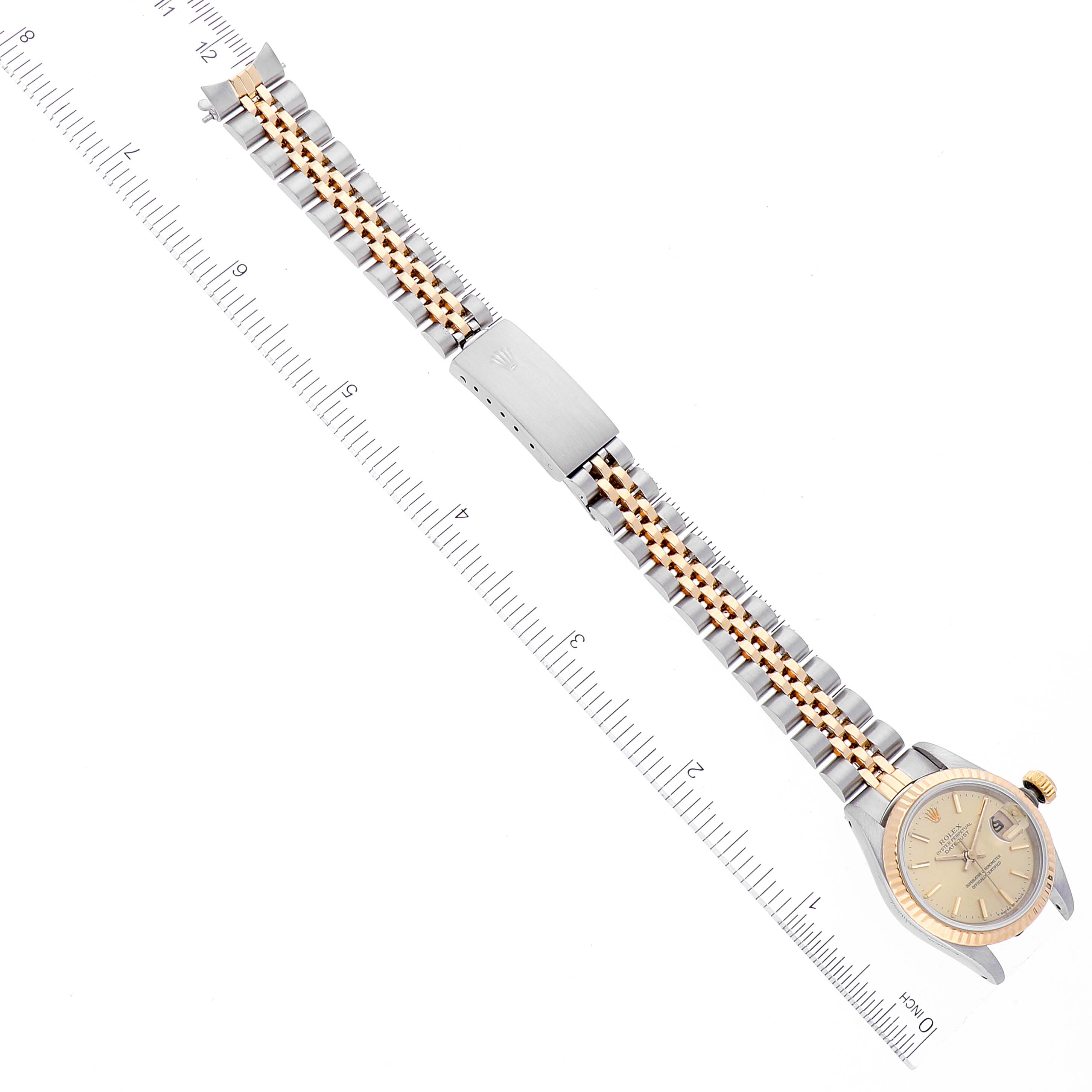 This image shows a top-down view of a Rolex Datejust 69173 Women's Steel and Gold (two tone) Champagne Dial 69173 Women's Steel and Gold (two tone) Champagne Dial watch, displaying the full band and face next to a measuring scale.