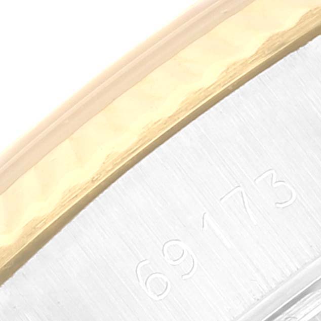 This close-up angle shows the outer edge and part of the bezel of the Rolex Datejust 69173 Women's Steel and Gold (two tone) Champagne Dial 69173 Women's Steel and Gold (two tone) Champagne Dial watch with some engraved numbers.