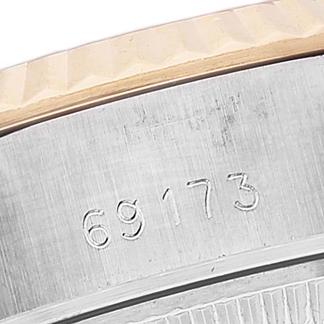 This close-up image of a Rolex Datejust 69173 Women's Steel and Gold (two tone) Champagne Dial 69173 Women's Steel and Gold (two tone) Champagne Dial watch shows the engraved model number "69173" and part of the bezel.