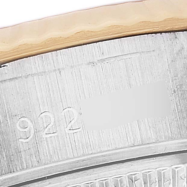 This image shows a close-up of the engraved serial number and a portion of the bezel on a Rolex Datejust 69173 Women's Steel and Gold (two tone) Champagne Dial 69173 Women's Steel and Gold (two tone) Champagne Dial watch.