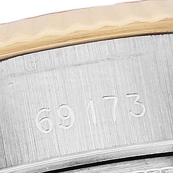 The image shows a close-up of the case side number engraving of a Rolex Datejust 69173 Women's Steel and Gold (two tone) Champagne Dial 69173 Women's Steel and Gold (two tone) Champagne Dial model.