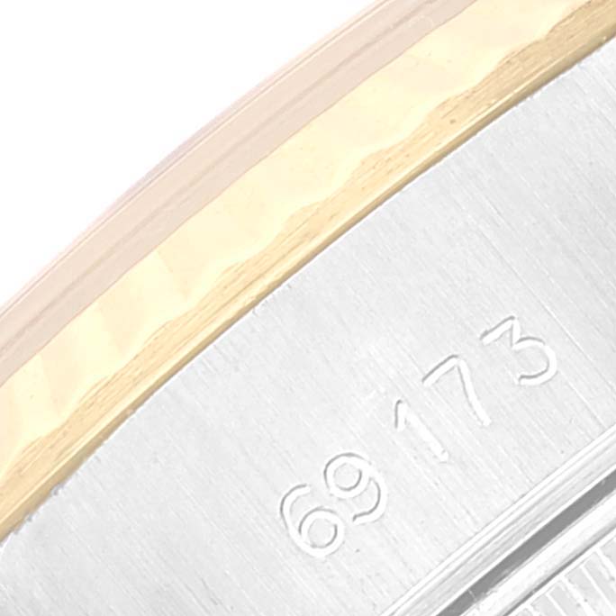 The image shows a close-up of the side bezel and part of the engraved serial number of a Rolex Datejust 69173 Women's Steel and Gold (two tone) Champagne Dial 69173 Women's Steel and Gold (two tone) Champagne Dial watch.