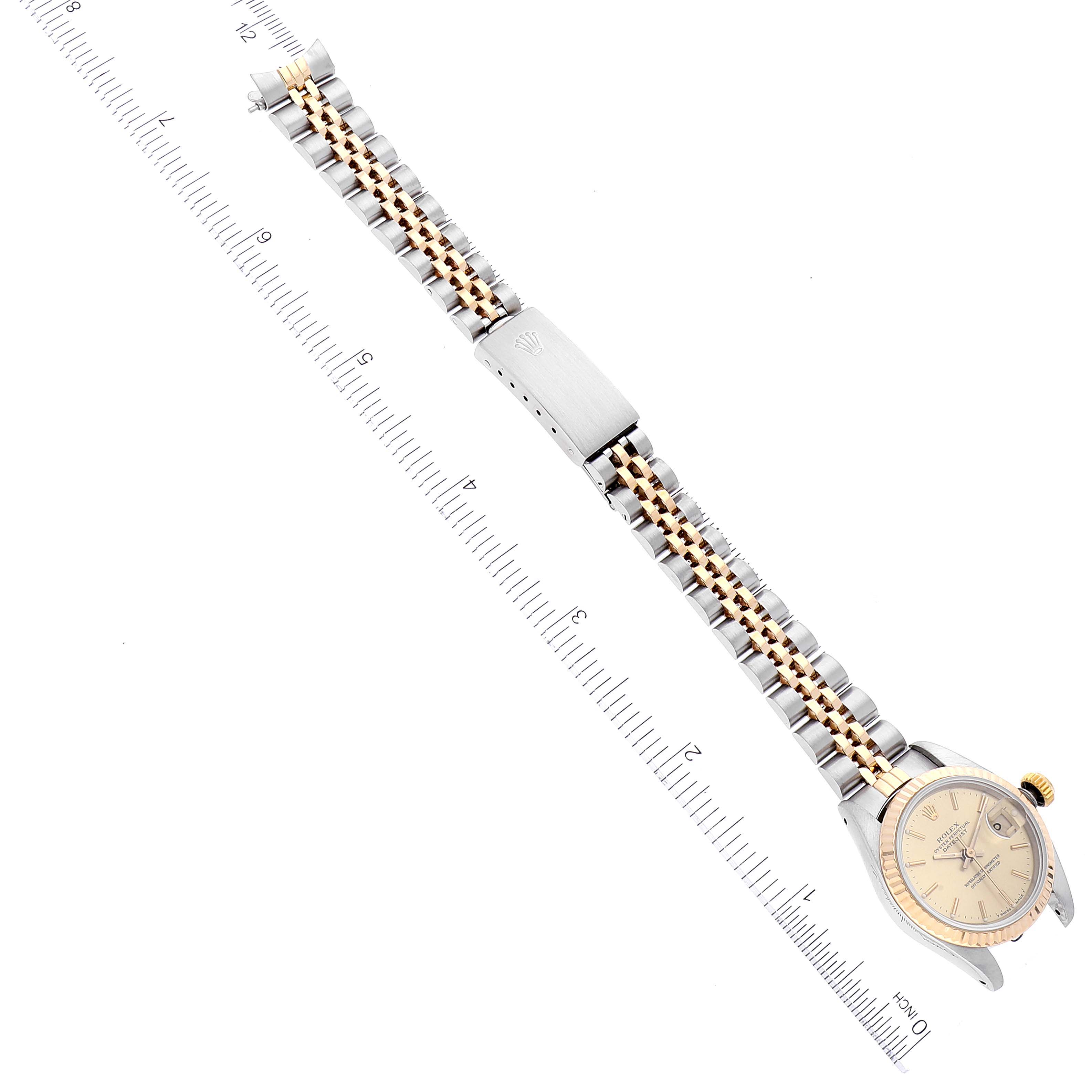 The image shows a Rolex Datejust 69173 Women's Steel and Gold (two tone) Champagne Dial 69173 Women's Steel and Gold (two tone) Champagne Dial watch laid flat, featuring its dial, bezel, and two-tone metal bracelet on a ruler for scale.
