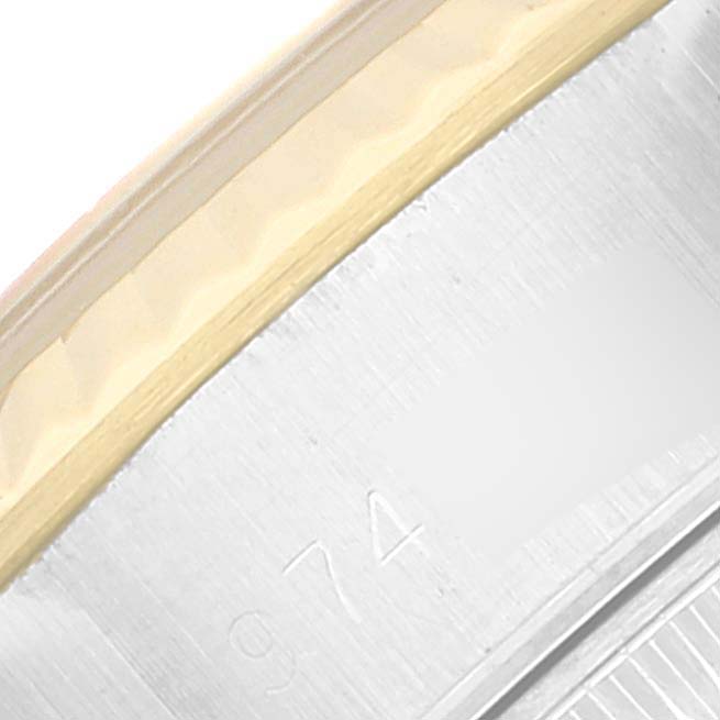 This close-up image shows the fluted bezel and part of the case with serial numbers on a Rolex Datejust 69173 Women's Steel and Gold (two tone) Champagne Dial 69173 Women's Steel and Gold (two tone) Champagne Dial watch.