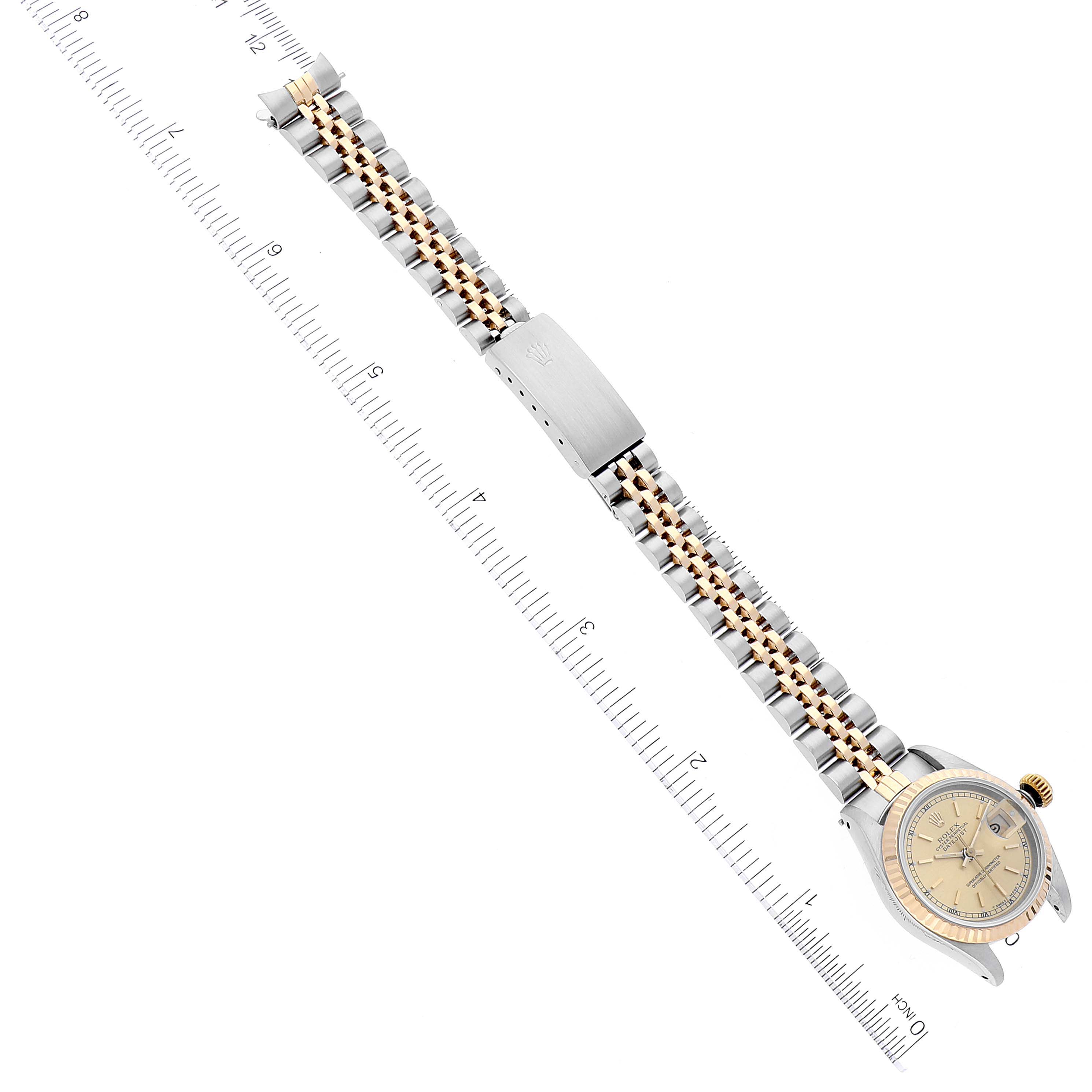 The image shows the Rolex Datejust 69173 Women's Steel and Gold (two tone) Champagne Dial 69173 Women's Steel and Gold (two tone) Champagne Dial watch laid flat from a top-down angle, featuring the dial, case, and the full bracelet.
