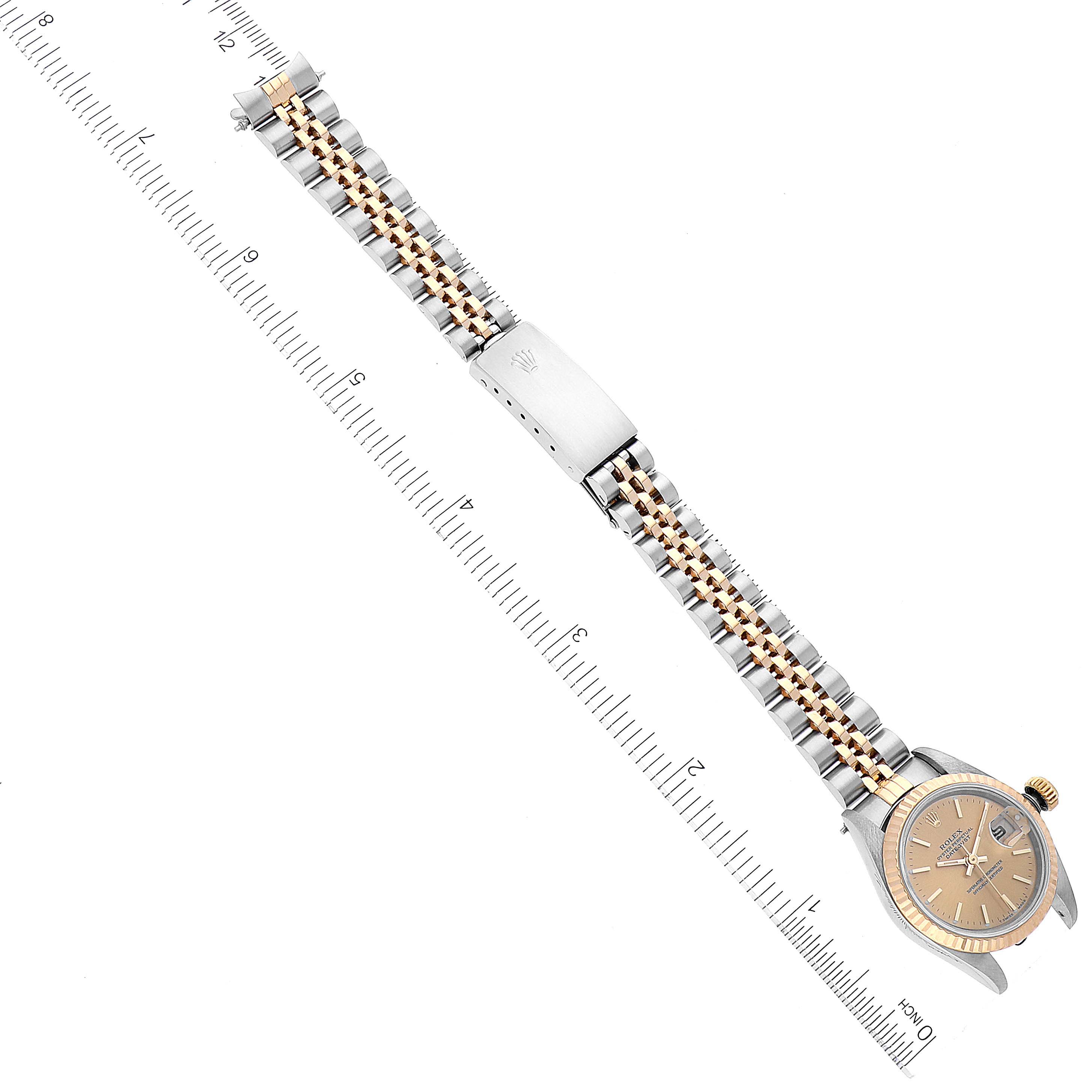 This image shows a top view of a Rolex Datejust 69173 Women's Steel and Gold (two tone) Champagne Dial 69173 Women's Steel and Gold (two tone) Champagne Dial watch laid flat next to a ruler, displaying the bracelet and dial.