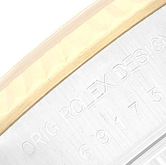 This image shows an angled close-up of the bezel and the engraved part of the case from a Rolex Datejust 69173 Women's Steel and Gold (two tone) Champagne Dial 69173 Women's Steel and Gold (two tone) Champagne Dial watch.