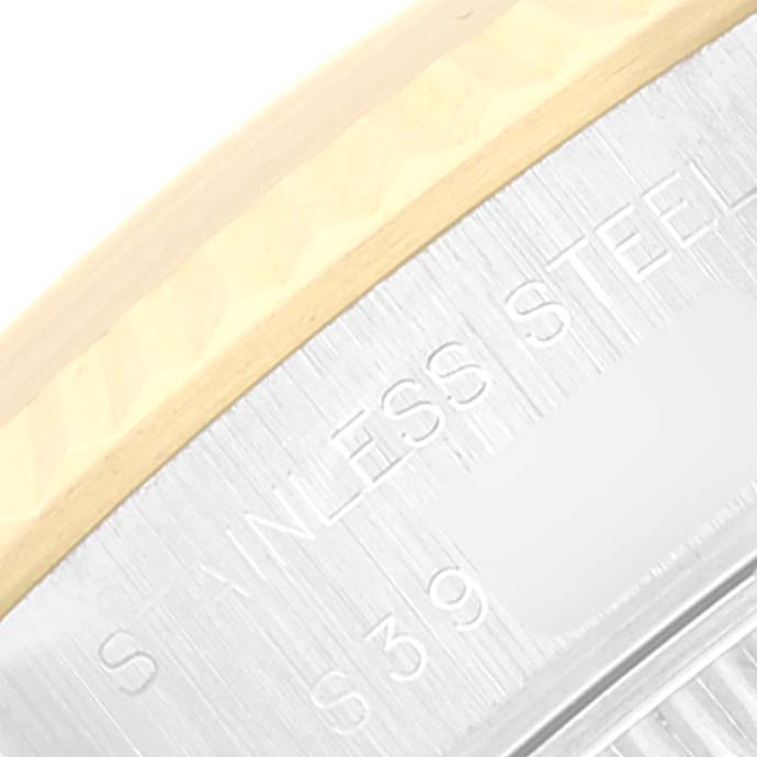 The image shows a close-up of the brushed stainless steel case back edge and part of the gold trim of a Rolex Datejust 69173 Women's Steel and Gold (two tone) Champagne Dial 69173 Women's Steel and Gold (two tone) Champagne Dial model watch.