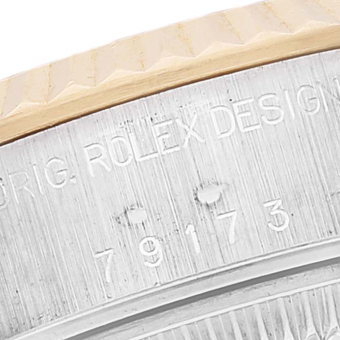 This image shows a close-up of the model number and part of the bezel of a Rolex Datejust 79173 Women's Steel and Gold (two tone) Mother of Pearl Dial 79173 Women's Steel and Gold (two tone) Mother of Pearl Dial watch.