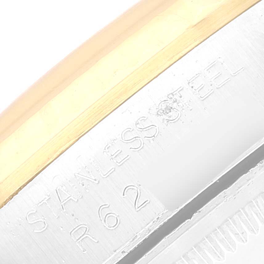 The image shows a close-up of the engraving on the side of the bezel of a Rolex Datejust 16233 Men's Steel and Gold (two tone) Silver Dial 16233 Men's Steel and Gold (two tone) Silver Dial watch.