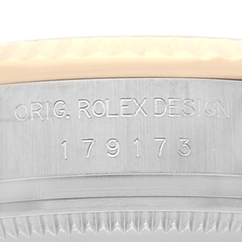 This image shows a close-up of the case engraving and bezel of a Rolex Datejust 179173 Women's Steel and Gold (two tone) Grey Dial 179173 Women's Steel and Gold (two tone) Grey Dial watch.