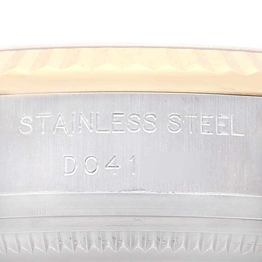 This image shows the side bezel and "stainless steel" engraving of the Rolex Datejust 179173 Women's Steel and Gold (two tone) Grey Dial 179173 Women's Steel and Gold (two tone) Grey Dial watch with an identifiable engraving code "D041".