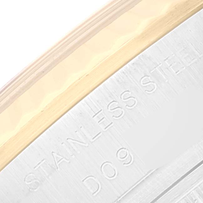 The image shows a close-up of the side of a stainless steel Rolex Datejust 179173 Women's Steel and Gold (two tone) Black Dial 179173 Women's Steel and Gold (two tone) Black Dial watch with part of the bezel and engraving visible.