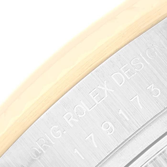 This image shows the case back with engraved text on a Rolex Datejust 179173 Women's Steel and Gold (two tone) Black Dial 179173 Women's Steel and Gold (two tone) Black Dial watch, viewed from a close-up angle.