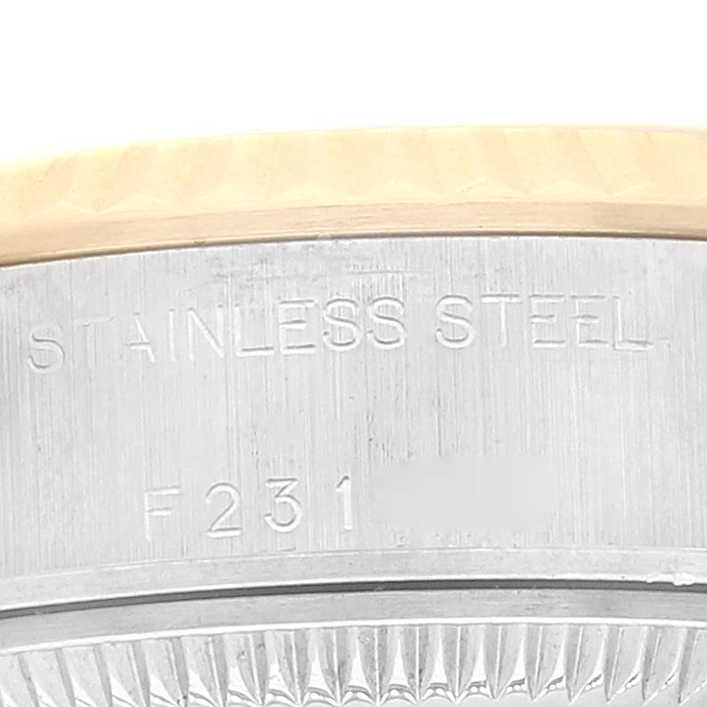Close-up of the side of the Rolex Datejust 79173 Women's Steel and Gold (two tone) White Dial 79173 Women's Steel and Gold (two tone) White Dial watch case, showing the "STAINLESS STEEL" engraving and the serial number.
