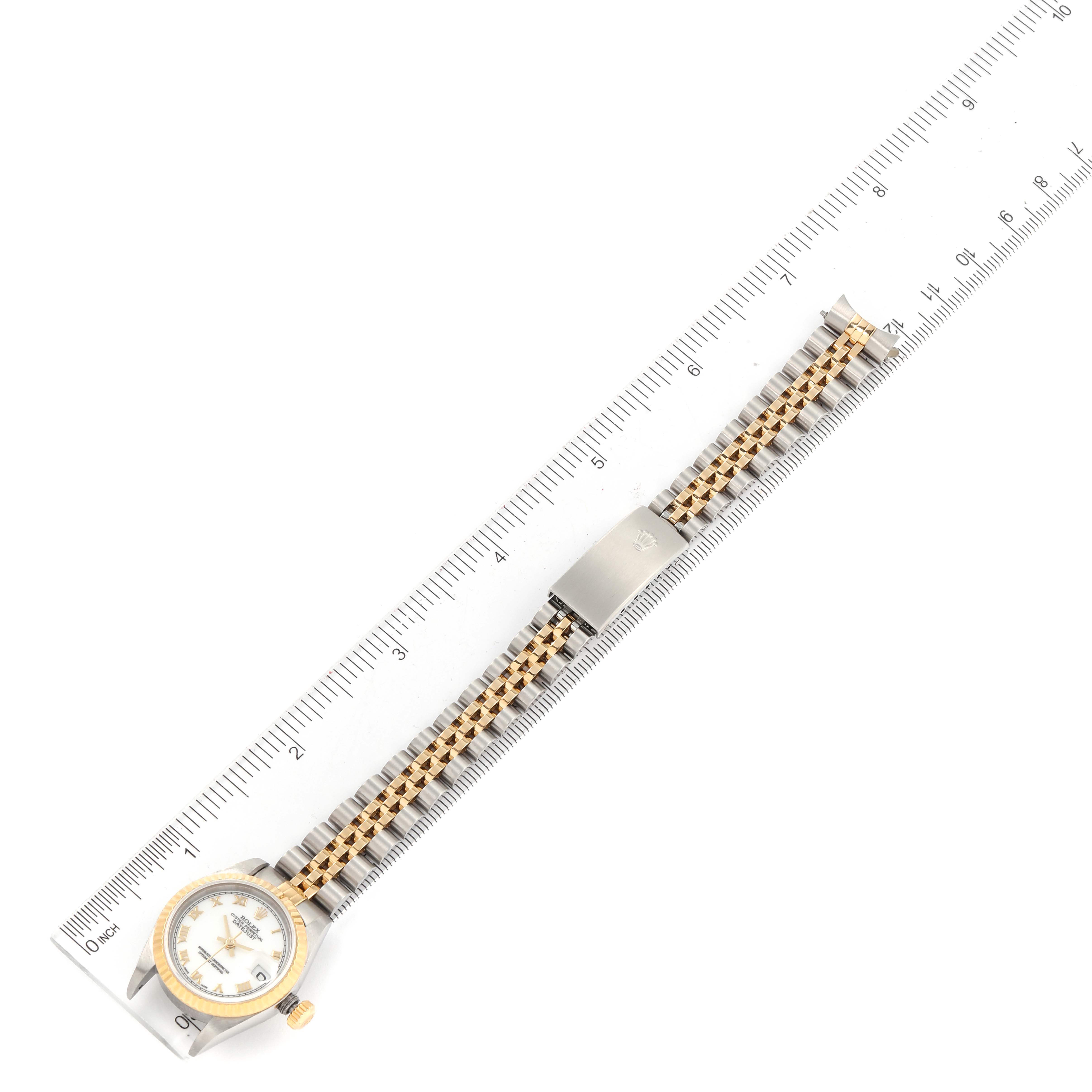 The image shows a Rolex Datejust 79173 Women's Steel and Gold (two tone) White Dial 79173 Women's Steel and Gold (two tone) White Dial watch at a top-down angle, alongside a ruler for scale.