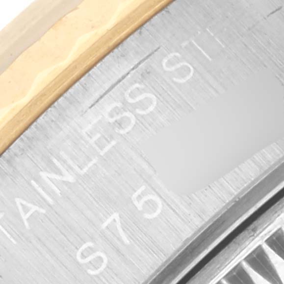 The image shows a close-up of the Rolex Datejust 69173 Women's Steel and Gold (two tone) White Dial 69173 Women's Steel and Gold (two tone) White Dial's bezel and part of the case with engraving visible.