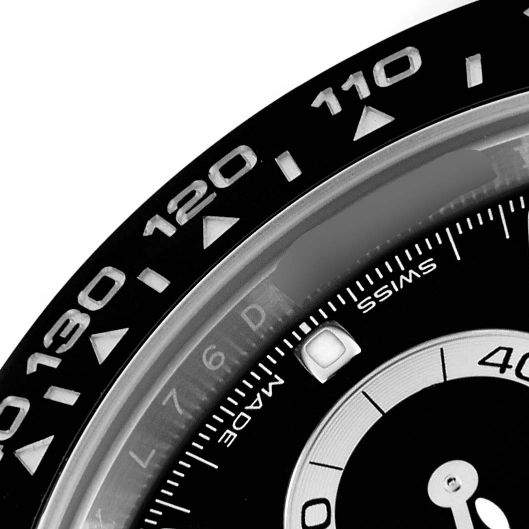 The image shows a close-up of the bezel and part of the dial of a Rolex Daytona 116500LN Men's Stainless Steel Black Dial 116500LN Men's Stainless Steel Black Dial, including some of the tachymetric scale.