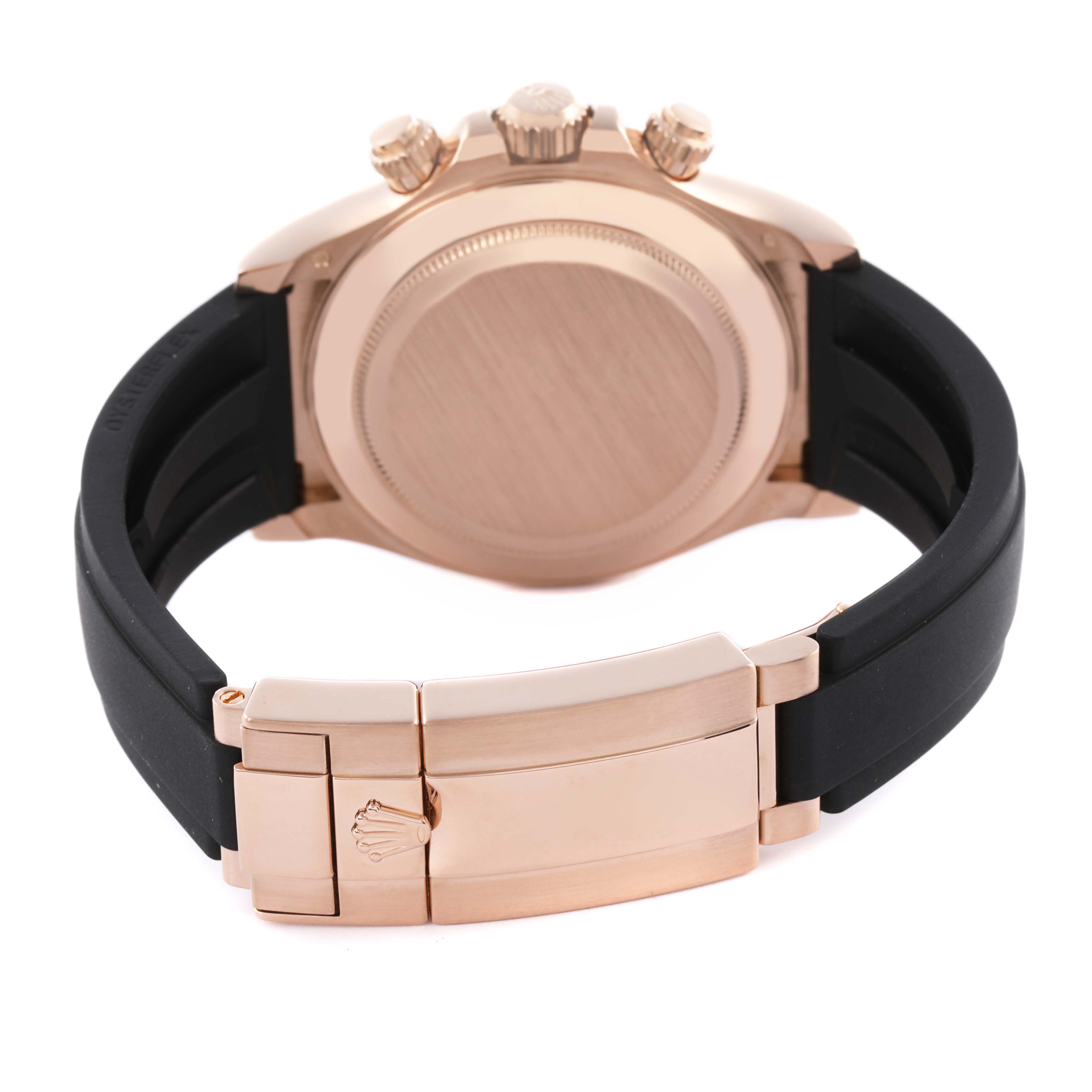 The image shows the back case, clasp, and part of the band of a Rolex Daytona 116515LN Men
s Rose Gold Brown Dial 116515LN Men
s Rose Gold Brown Dial watch.