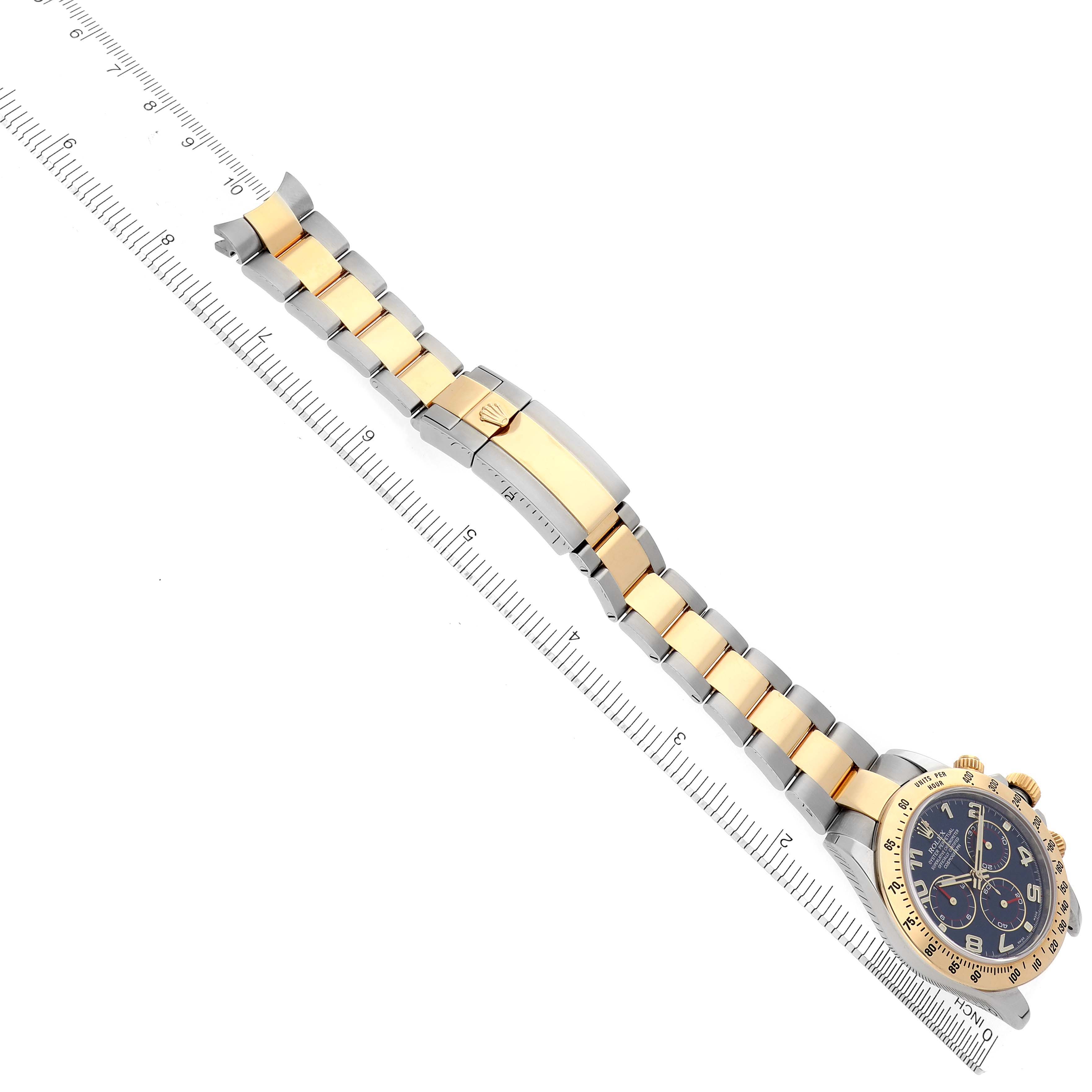 The Rolex Daytona 116523 Men's Steel and Gold (two tone) Blue Dial 116523 Men's Steel and Gold (two tone) Blue Dial watch is shown from a top view, focusing on the bracelet and clasp.