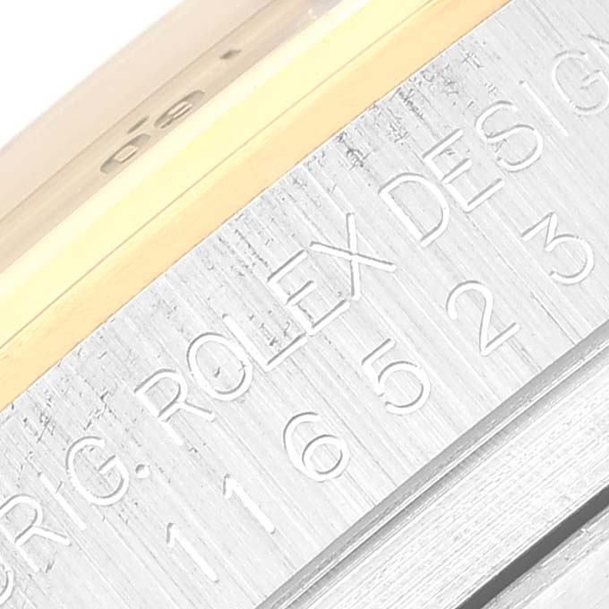 Close-up of the side engraving on a Rolex Daytona 116523 Men's Steel and Gold (two tone) White Dial 116523 Men's Steel and Gold (two tone) White Dial watch, showing "ORIG. ROLEX DESIGN" and model number.