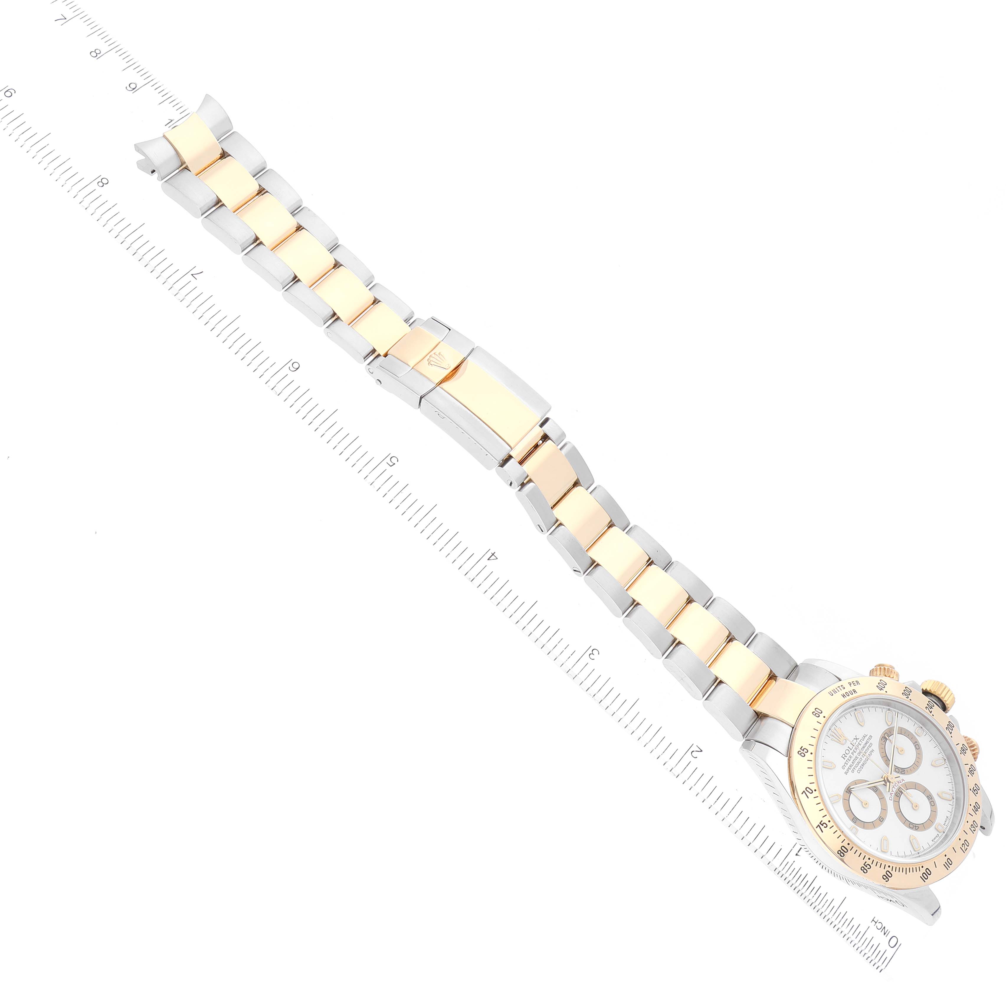 The image shows a Rolex Daytona 116523 Men's Steel and Gold (two tone) White Dial 116523 Men's Steel and Gold (two tone) White Dial watch viewed from a top-down angle, displaying the face and full band with a measurement scale.