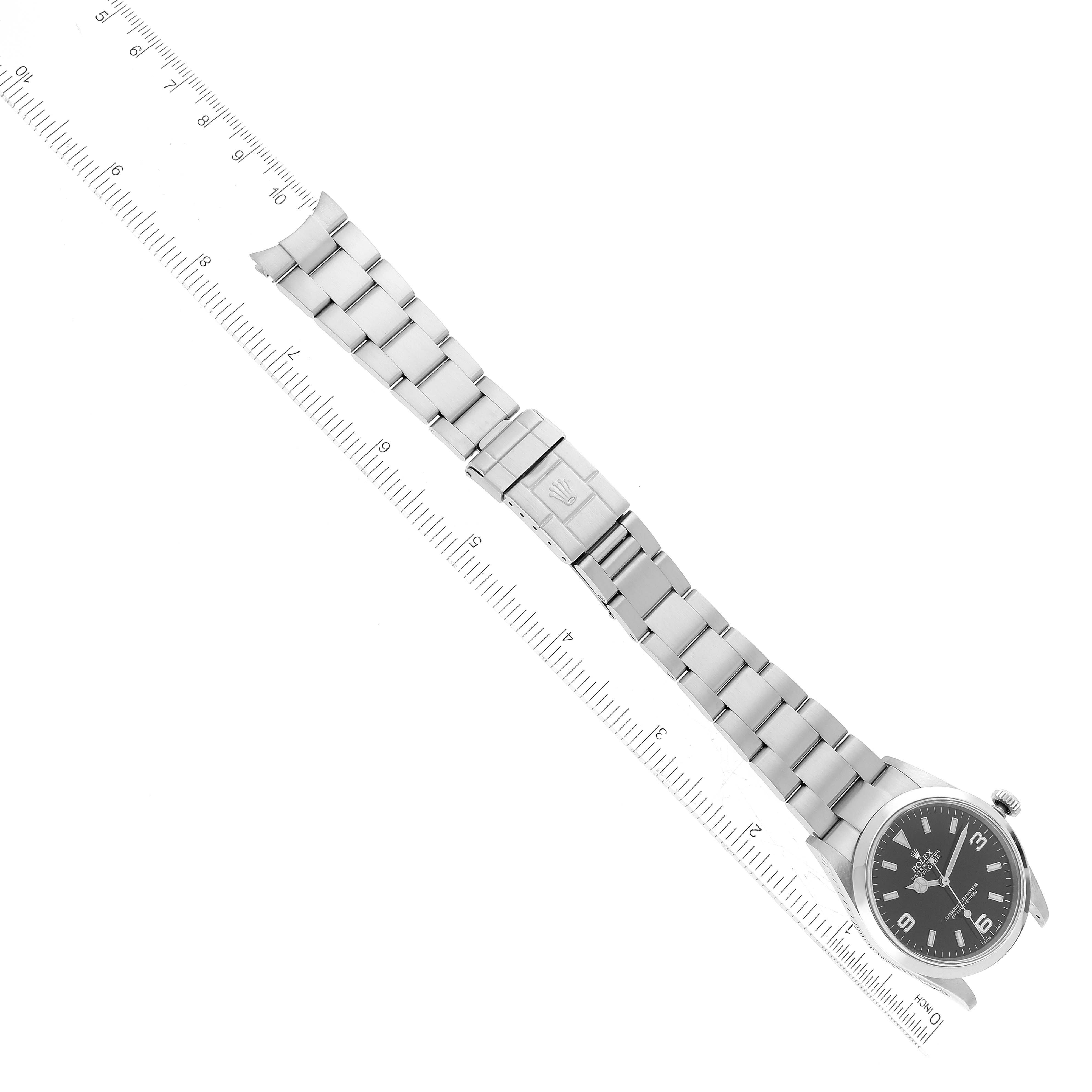 The image shows a top view of a Rolex Explorer 114270 Men's Stainless Steel Black Dial 114270 Men's Stainless Steel Black Dial watch laid flat next to a ruler for measurement.