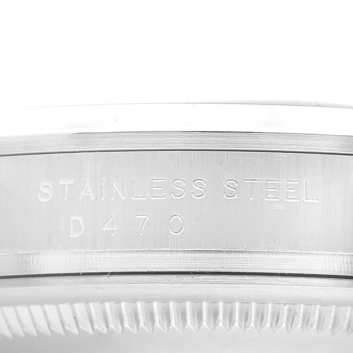 This is a close-up of the side of a Rolex Explorer 114270 Men's Stainless Steel Black Dial 114270 Men's Stainless Steel Black Dial watch, showing the "STAINLESS STEEL" engraving and part of the bezel.