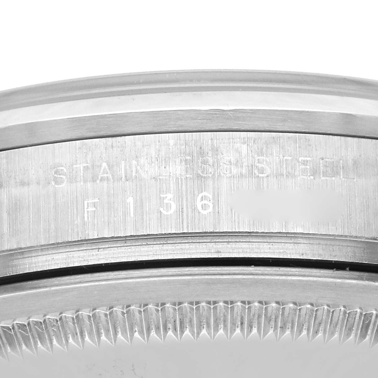 The image shows a close-up of the Rolex Explorer 114270 Men's Stainless Steel Black Dial 114270 Men's Stainless Steel Black Dial's stainless steel casing with engraved serial numbers.