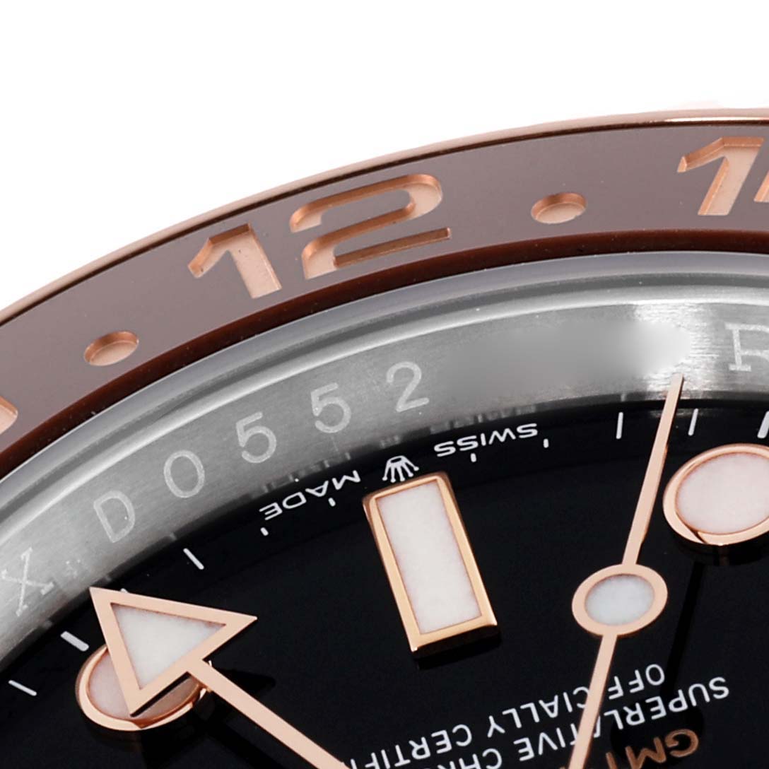 This image shows a close-up of the dial, bezel, and GMT hand of a Rolex GMT-Master 126711CHNR Men's Steel and Gold (two tone) Black Dial 126711CHNR Men's Steel and Gold (two tone) Black Dial watch.
