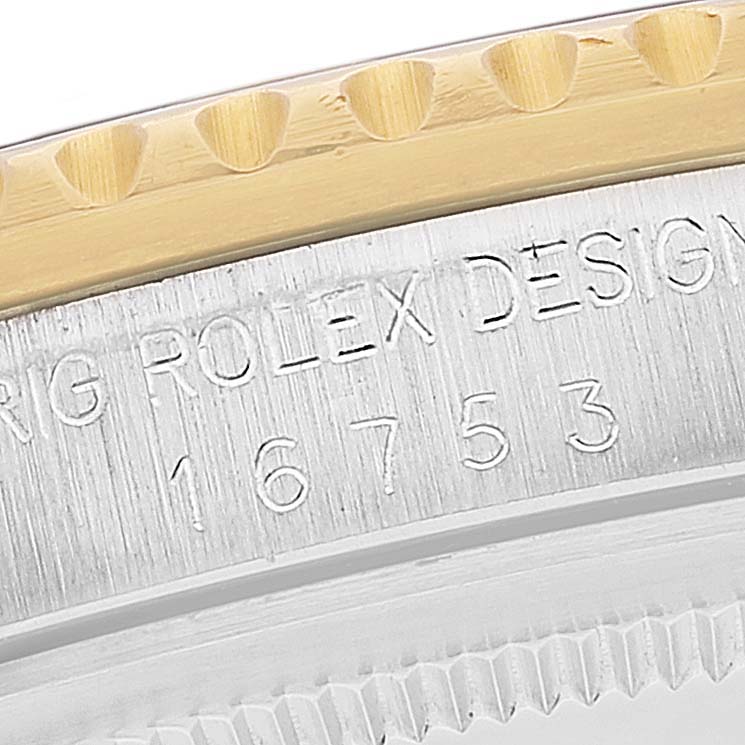 This image shows a close-up of the bezel and engraved case side of a Rolex GMT-Master 16753 Men's Steel and Gold (two tone) Black Dial 16753 Men's Steel and Gold (two tone) Black Dial watch, including the model number 16753.