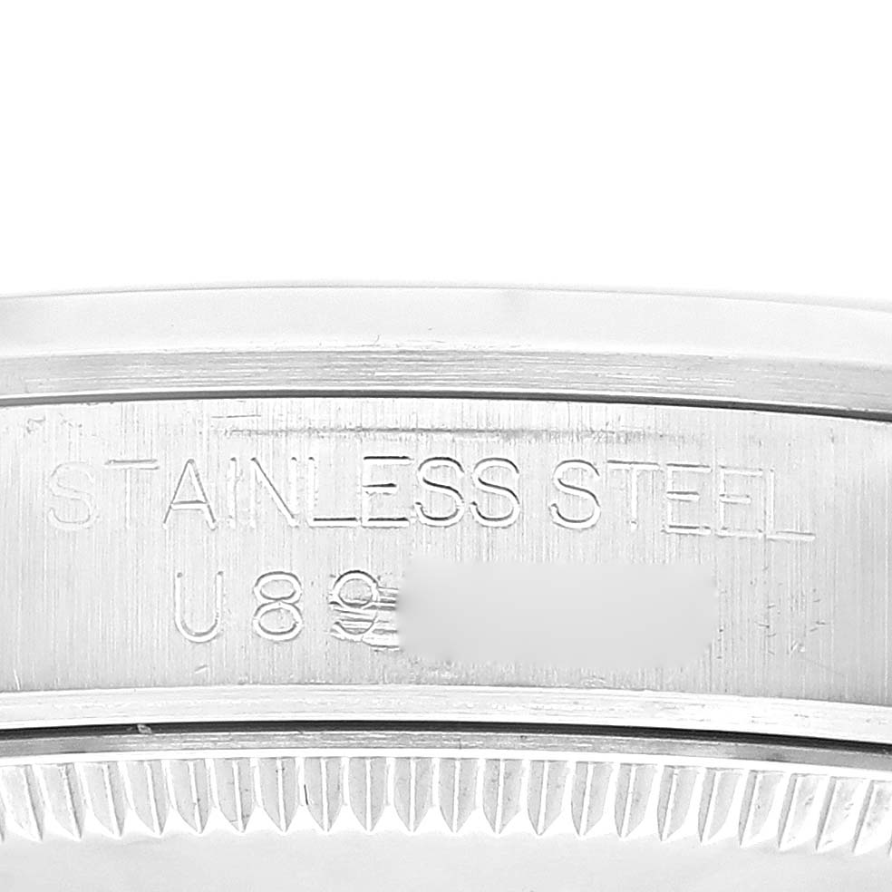 This image shows a close-up of the engraved stainless steel case back edge of a Mid-Size Rolex watch.