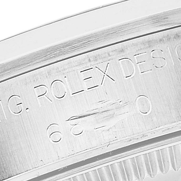 This image shows a close-up of the bezel and engraved model number of a Mid-Size Rolex watch.