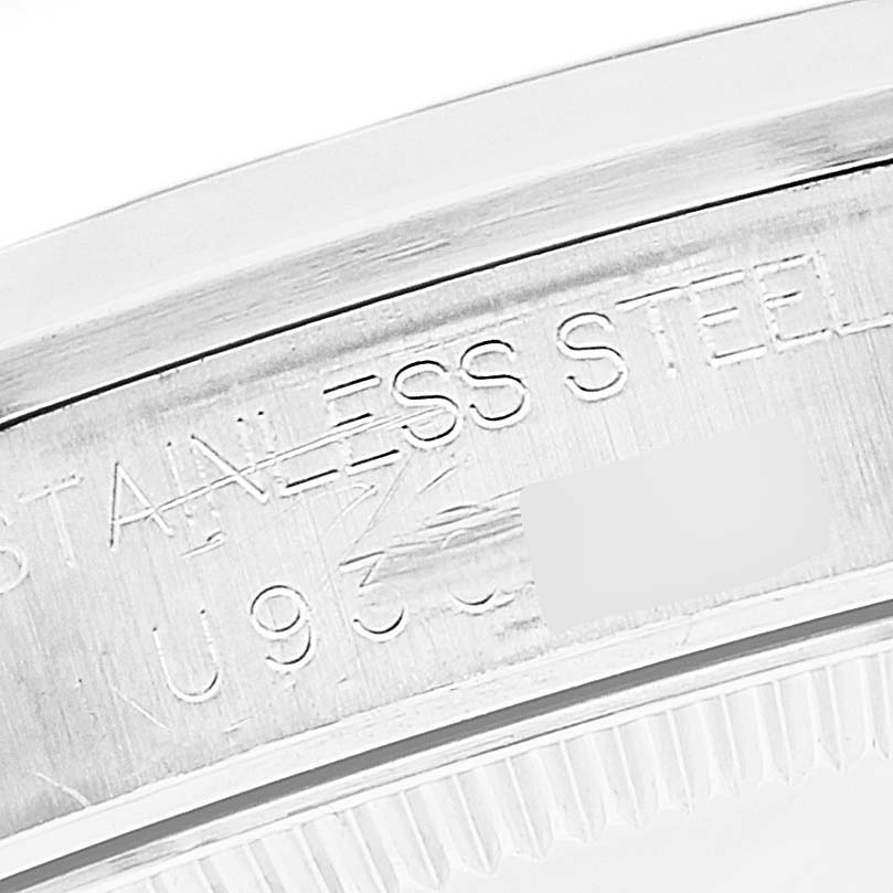 The image shows a close-up of the case back edge and serial number engraving on a Rolex Mid-Size 68240 Women
s Stainless Steel Blue Dial 68240 Women
s Stainless Steel Blue Dial model stainless steel watch.