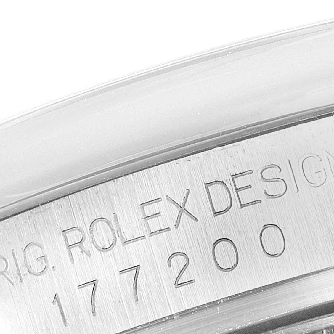 This close-up image shows the engraved lettering and serial number on the case of a mid-size Rolex watch, model 177200.