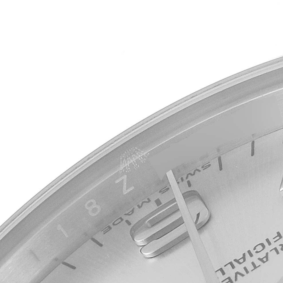 The image shows a close-up of the dial and hands of a mid-size Rolex watch, focusing on the hour markers and the "Swiss Made" text.