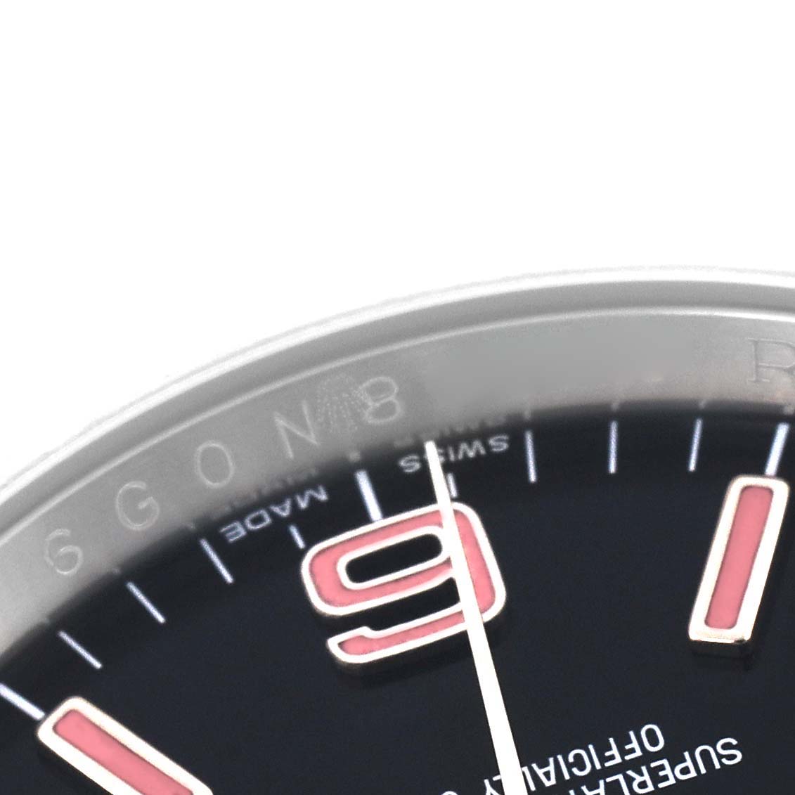 The image shows a close-up of the dial and bezel of a Rolex Oyster Perpetual 116000 Men
s Stainless Steel Black Dial 116000 Men
s Stainless Steel Black Dial, highlighting the numeral "9" and part of the watch
s text.
