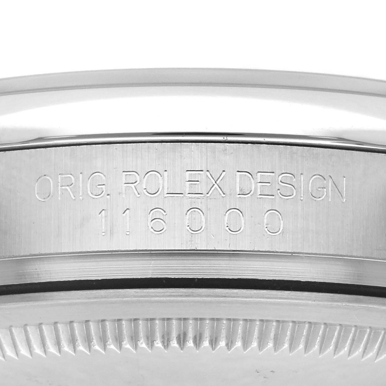 The image shows a side view of the case back edge of a Rolex Oyster Perpetual 116000 Men
s Stainless Steel Black Dial 116000 Men
s Stainless Steel Black Dial model, featuring the design and model number engraving.