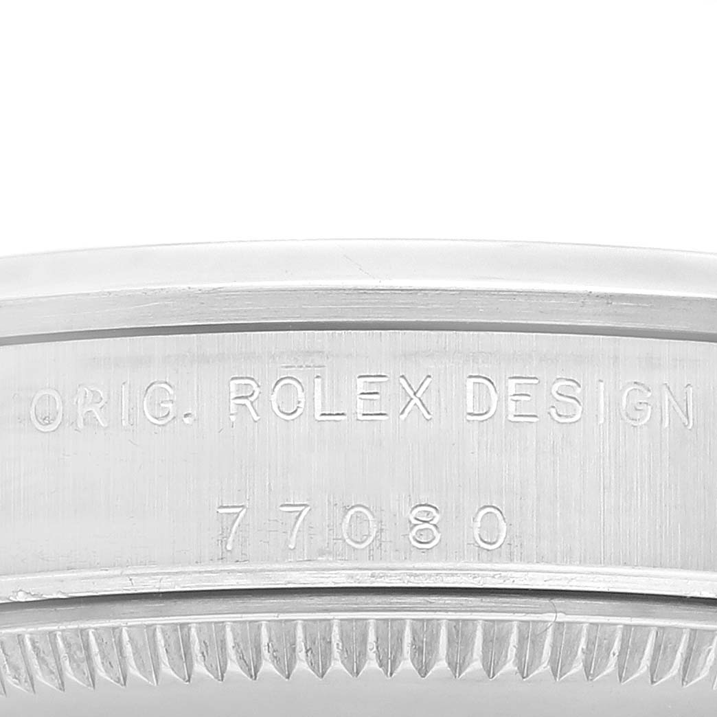 The image shows an angled close-up of the case side of a Mid-Size Rolex watch, featuring engraved text "ORIG. ROLEX DESIGN" and model number "77080".
