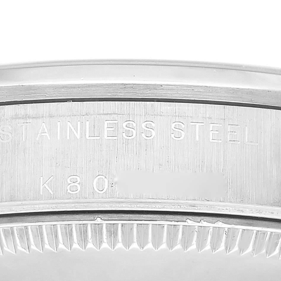 The image shows the inner rim and part of the case back of a Mid-Size Stainless Steel Rolex watch.