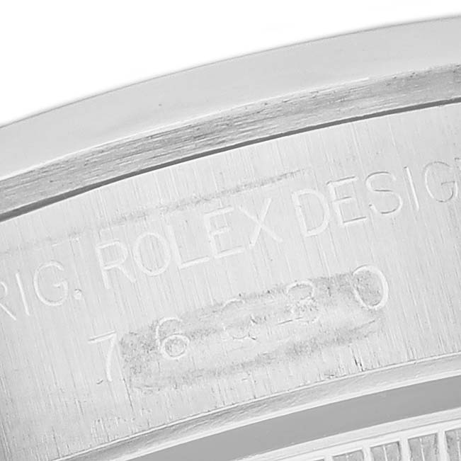 This is a close-up image showing the engraved details on the case back of a Rolex Oyster Perpetual 76080 Women's Stainless Steel Silver Dial 76080 Women's Stainless Steel Silver Dial watch.